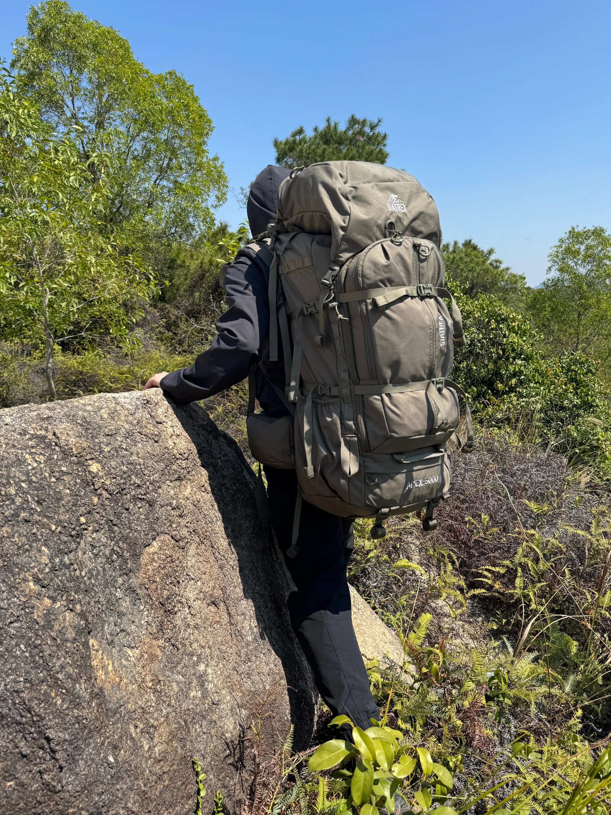 SIATREX APEX 5000 backpack displayed with hunting gear, showing multiple compartments and durable design